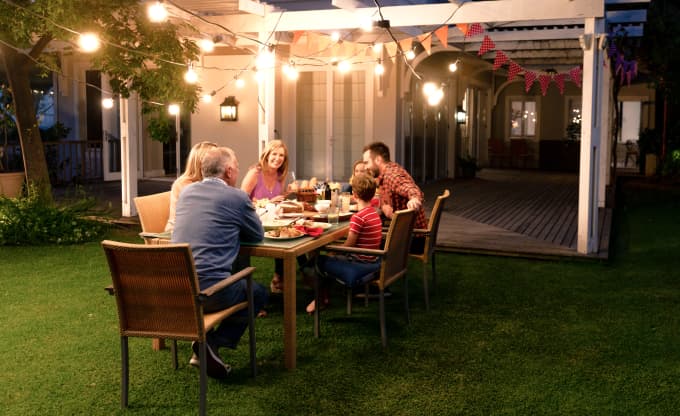 Photo of a family enjoying a meal on their patio